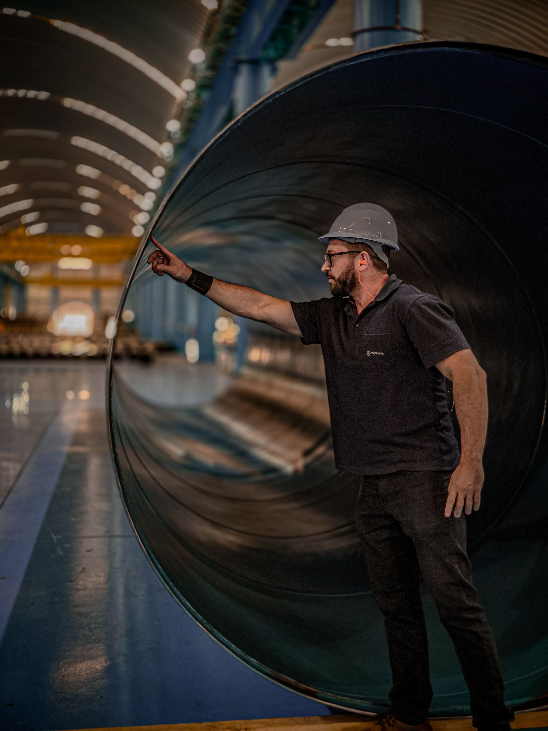 Engineer assessing a large fabricated steel pipe